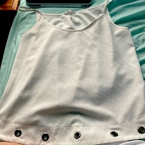 A tank top with it gets bigger as you go down and has metal hoops at the bottom